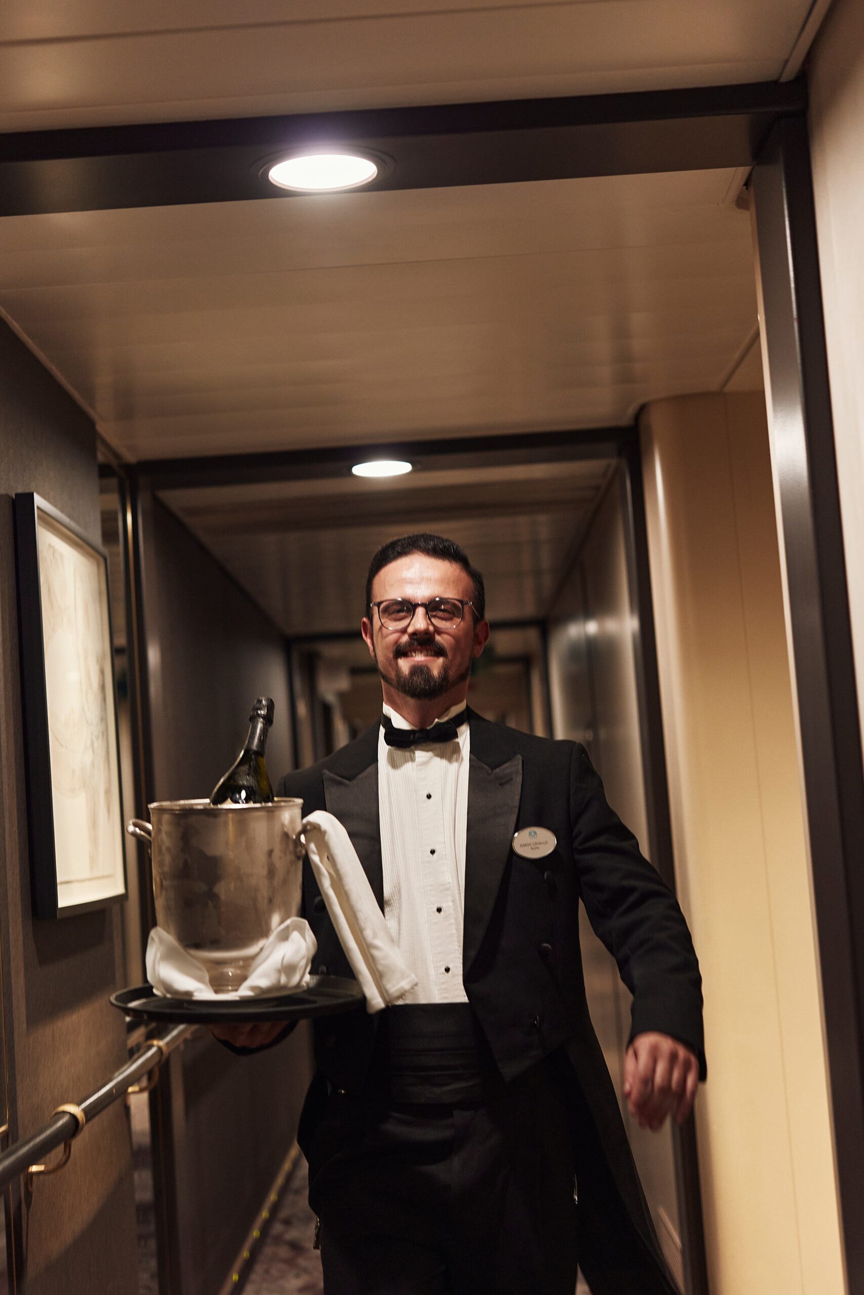 A butler aboard a Crystal Cruises chip carries champagne on ice