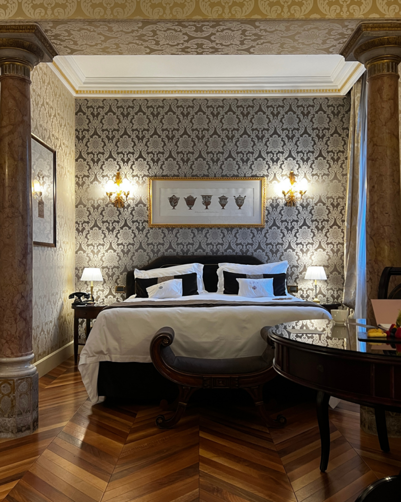 A photo of a king bed in a guest room at Londra Palace, a luxury hotel in Venice